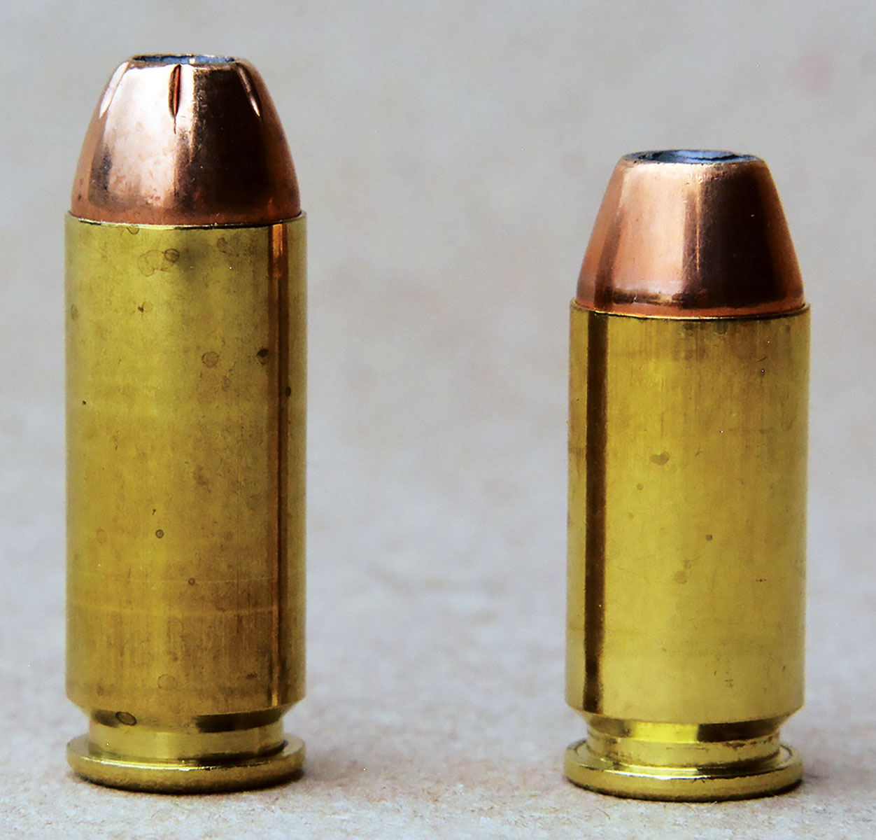 The 10mm Auto (left) is potent and some law  enforcement agencies found the recoil excessive. The 40 S&W was developed with a blend of  lowered recoil and still offer adequate performance for defensive and law enforcement, but could be offered lighter, smaller pistols.